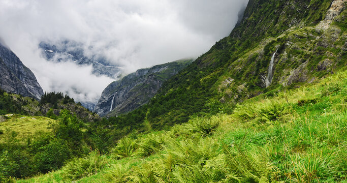 Wild alpine landscape with two waterfalls at a cloudy day in summer. Maderanertal, glarus alps, uir, switzerland europa