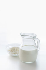 Milk in a jug and cottage cheese in a bowl