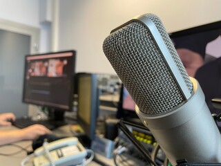 microphone hangs on the background of monitors