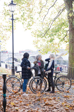 Portrait confident, smiling senior women bike riding in autumn park