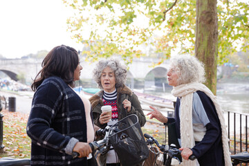 Fototapeta premium Portrait confident, smiling senior women bike riding in autumn park