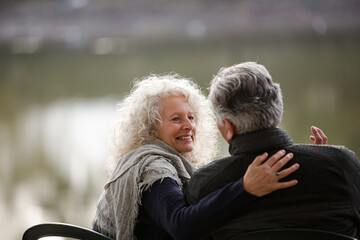 Affectionate, tender senior couple hugging in autumn park
