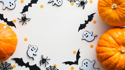Cute halloween flat lay composition with pumpkins, ghosts, bats, spiders, web on white background....