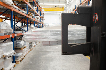 Pallets and equipment on shelves in warehouse