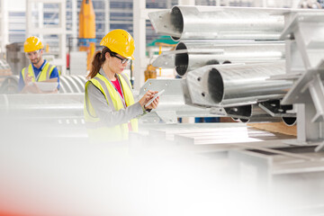 Workers with digital tablet working in factory