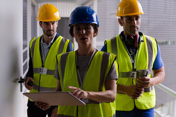 Supervisors and worker with clipboard in factory