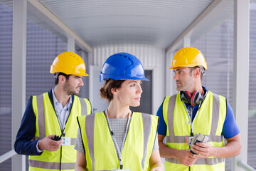 Supervisors and worker with clipboard in factory