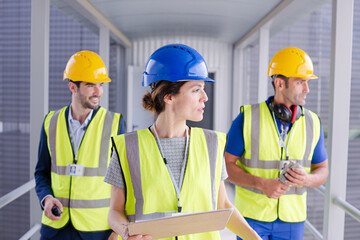 Supervisors and worker with clipboard in factory