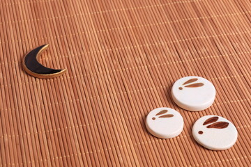 Japanese chopstick stands. With the image of a moon rabbit on the background of a bamboo mat. The concept of the mid-autumn
