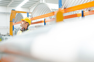 Naklejka premium Male worker looking up in factory