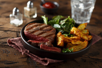 Beef steak with roasted potato and salad