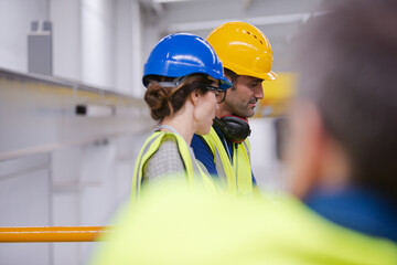 Supervisor and worker talking in steel factory