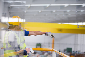 Supervisor and worker talking in steel factory