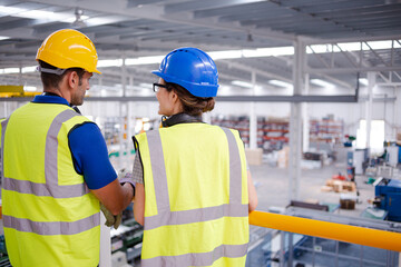 Supervisor and worker talking in steel factory