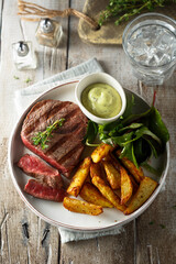 Beef steak with roasted potato and salad