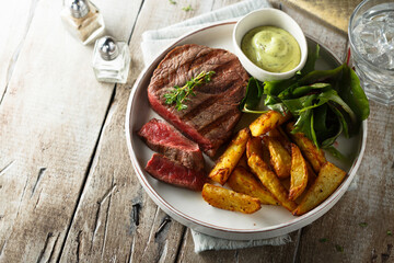 Beef steak with roasted potato and salad