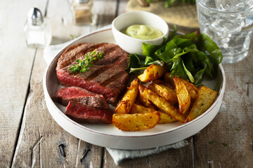 Beef steak with roasted potato and salad