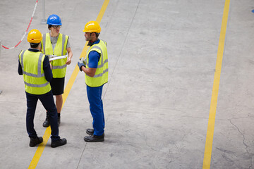 Supervisor and workers talking in factory