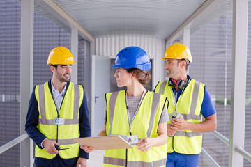 Supervisors and worker with clipboard in factory