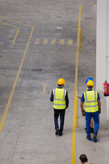 Supervisor and workers walking in factory