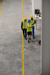 Supervisor and workers talking in factory