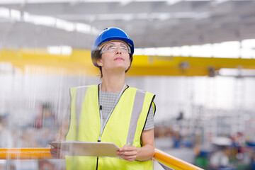 Portrait confident female supervisor with clipboard in steel factory