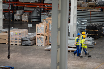 Workers and supervisor walking in factory