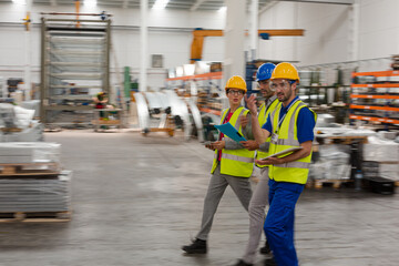 Supervisor and workers talking in warehouse