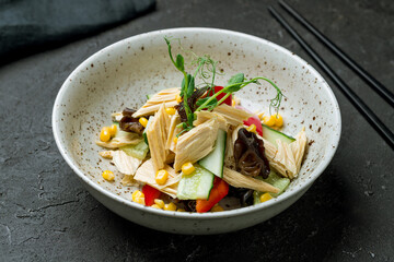 salad fuzhu with vegetables on plate on dark stone table