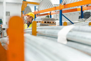 Male worker looking up in factory