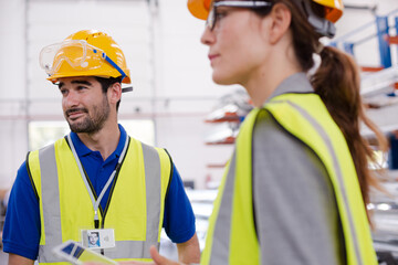 Workers talking in steel factory