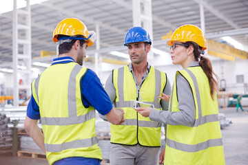Supervisor and workers talking in steel factory