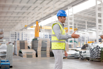 Supervisors handshaking in warehouse