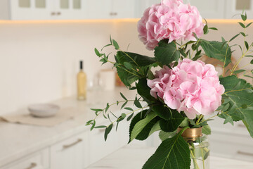 Beautiful pink hortensia flowers in vase indoors, closeup. Space for text