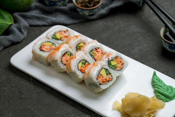 roll with spicy shrimp and crab on dark stone table side view