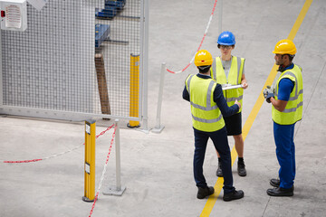 Supervisor and workers talking in factory