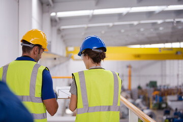 Smiling workers talking in factory