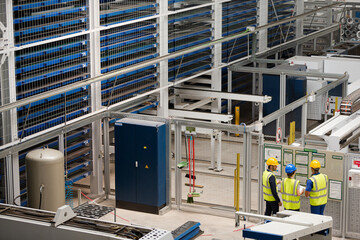 Supervisor and workers talking in factory