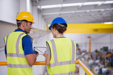 Supervisor and worker in factory