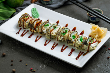 hot roll with chuka seaweed on plate on dark stone table