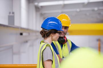 Supervisor and worker talking in steel factory