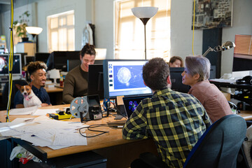 Colleagues working together at computer