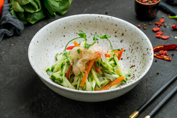 salad with jellyfish and vegetables on dark stone table © Алиса Королевская