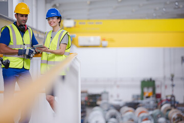 Supervisor and worker in steel factory