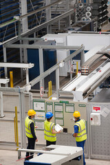 Supervisor and workers talking in factory