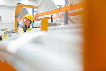 Male worker looking up in factory