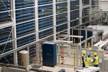 Supervisor and workers talking in factory