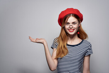 pretty woman in a striped t-shirt red lips gesture with his hands lifestyle