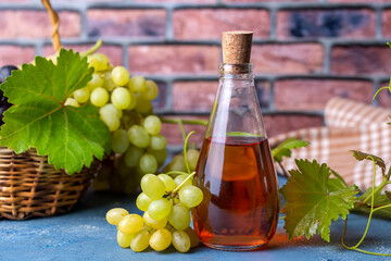 Wine vinegar in a glass jug, dark vintage wooden background, selective focus