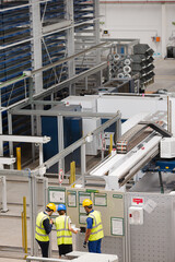 Supervisor and workers talking in factory